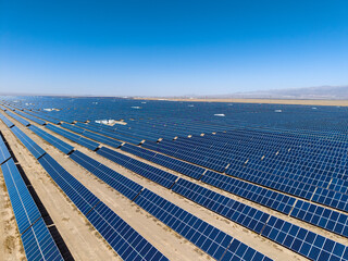 Expansive solar farm under a clear blue sky in Jiayuguan City, China, capturing renewable energy © AS_SleepingPanda