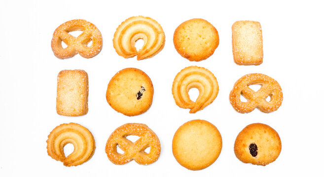 Assorted butter cookies in various shapes. Isolated on white background. Danish pastry and sweet food concept. Top view