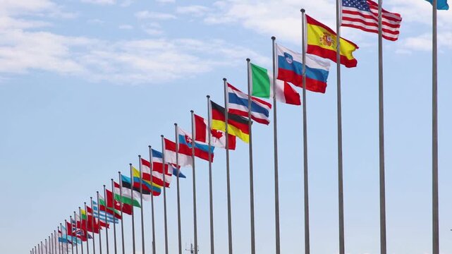 International Flags Waving in the Wind for Global Business, Diplomacy, and World News Backgrounds