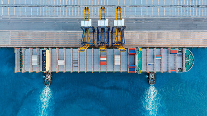 Aerial view large cargo ship loading shipping containers in port. © Teppakorn
