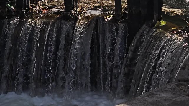 Locked-down video of the Grand Canal Lock, canal flowing closeup.