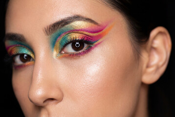 Naklejka premium Close up of woman eye with creative colorful makeup