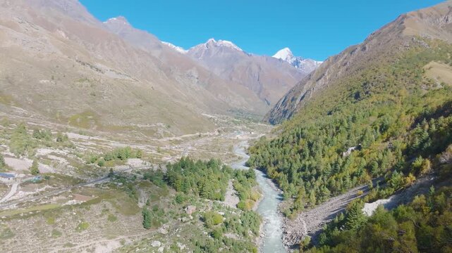 Epic wide drone reveal of the massive Kinnaur Valley and snow-capped Himalayan peaks.