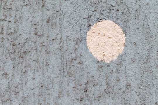 Light bluish pulled wall exterior plaster with yellowish paint circle background texture design
