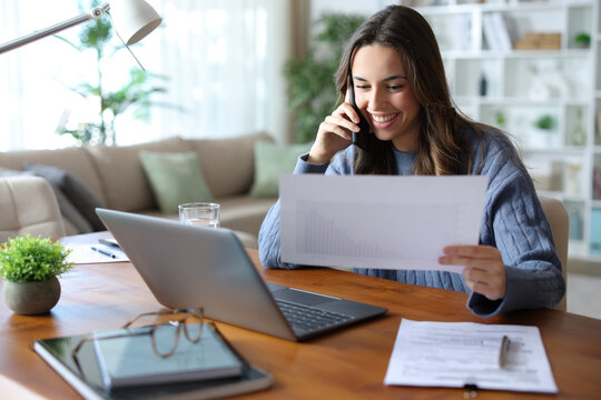 Happy freelance worker attending call working at home