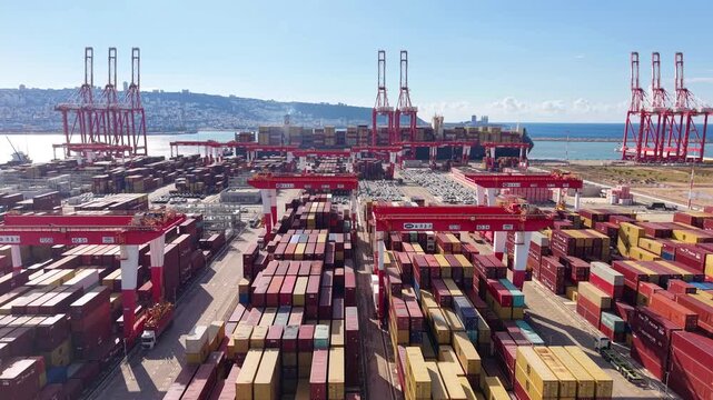 Aerial drone Haifa port containers cranes Mediterranean coastline Israel

Drone footage container terminal with cranes cargo stacks and parked vehicles Haifa port Israel 1.1.2026
