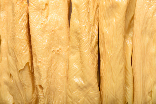 Macro shot of yellow tofu skin texture, organic protein background