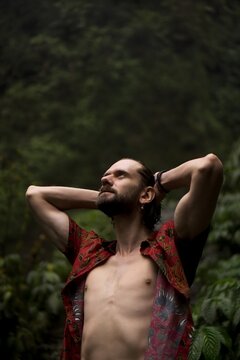 Man Hands Behind Head Looking Up in Tropical Jungle Nungnung Bali