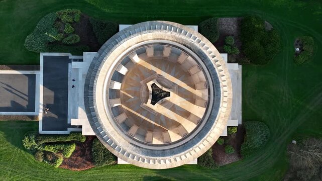 Top down aerial view of Butte de Montsec monument in Meuse department showing circular colonnade structure with geometric courtyard surrounded by green lawn