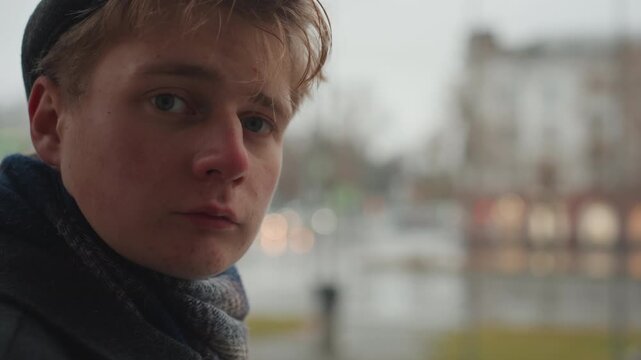 Closeup portrait white creator with raindrops turning from back to face, wet hair and flushed cheeks, subtle vulnerability and direct gaze, soft bokeh city lights and neon reflections, intimate moment