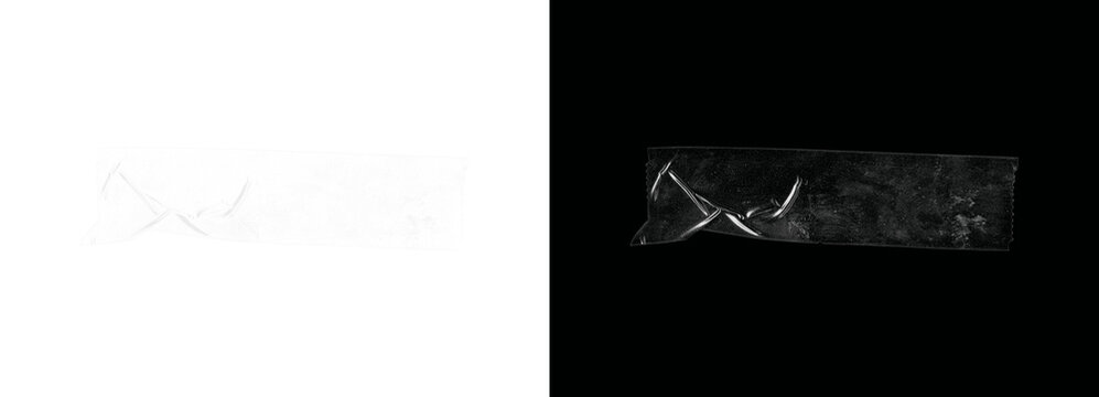 Roll of transparent tape on black background with white surface