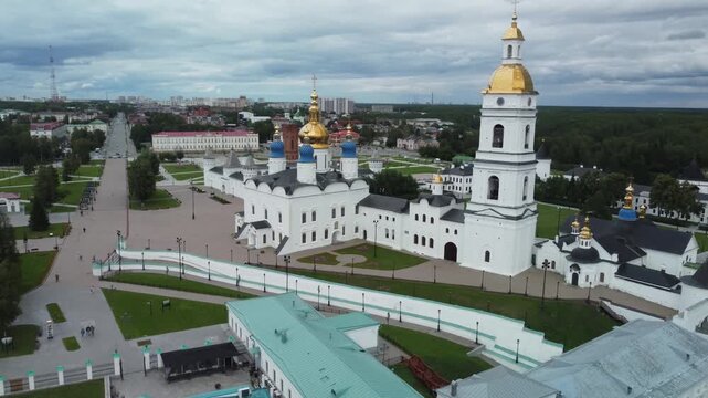 A breathtaking aerial drone view of Tobolsk Kremlin, a unique architectural landmark of Siberia, Russia. The shot captures the majestic white stone walls, cathedrals, and towers