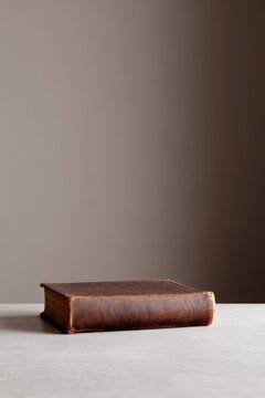 Hardcover book, front view, dust jacket, minimalist wall background