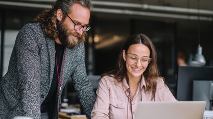 professionals wearing collaborate and talk at a modern office, showing teamwork, communication, and a positive work environment.