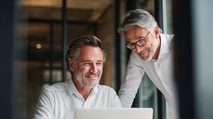 professionals wearing collaborate and talk at a modern office, showing teamwork, communication, and a positive work environment.