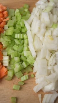 Italian soffritto ingredients onion celery and carrot on cutting board