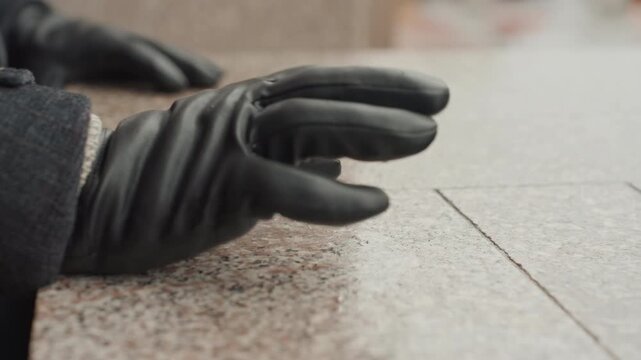 Hand gently touches. Caucasian on stone edge. Closeup of hand on granite in winter. Urban scene with hand contact on cold stone. Artistic depiction of hand on granite ledge during wintertime