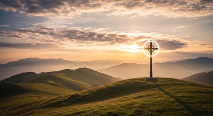 Obraz premium A serene mountain landscape with a cross on a hill at sunset with clouds and sun rays