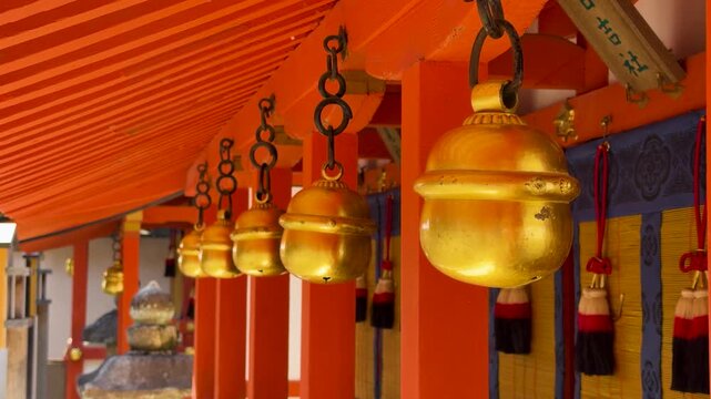 Golden Suzu Bells Hanging at a Traditional Shinto Shrine in Kyoto