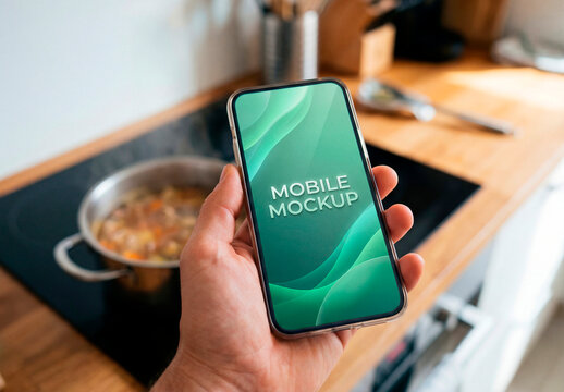 Smartphone mockup in hand over kitchen background