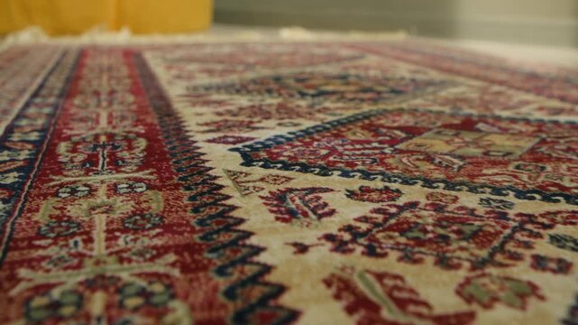 Detailed view traditional persian rug with intricate floral patterns, ornate borders, showing rich texture and colorful handmade craftsmanship of classic oriental textile. Traditional persian carpet.