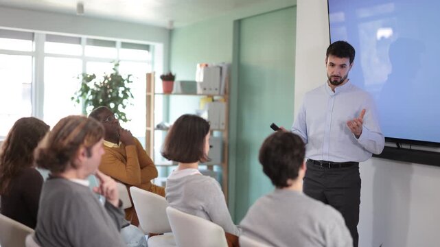 Group of attentive students listening to coach speaking on topic during educational session. High quality 4k footage