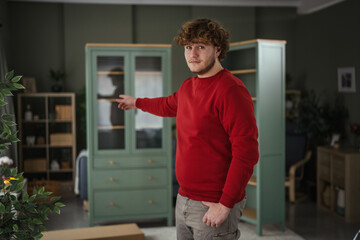 Fototapeta premium Man assembling new furniture in living room