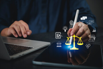 Lawyer using tablet stylus pointing scale justice digital interface legal technology AI chatbot law...