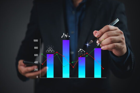 Businessman hand pointing pen at digital growth bar chart graph with real estate gold icons investment diversification wealth management portfolio analysis strategy.