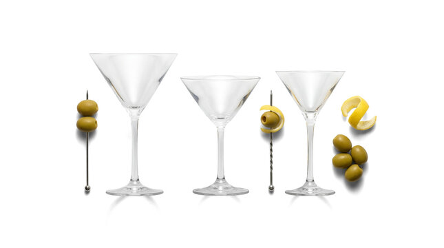 Elegant clear empty martini glasses, perfectly poised with classic green olive and vibrant lemon twist garnishes.
