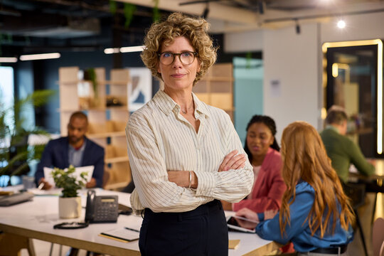 Satisied mature business woman looking at camera