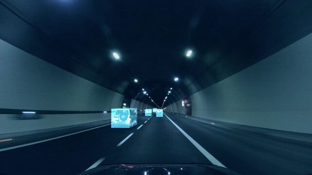 Inside view of a moving autonomous car with HUD elements. Self-driving a robot-controlled car moves through a tunnel, scans traffic and the road using sensors. Smart safe transport of the future. 