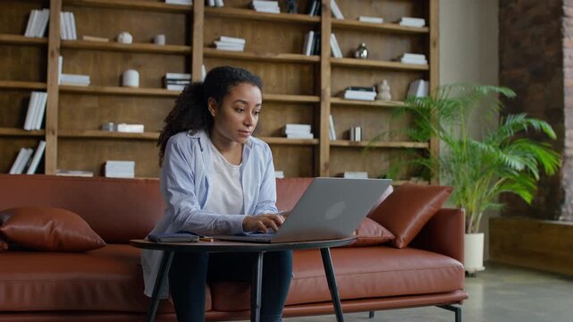Young woman working on laptop at home