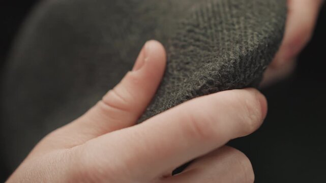 Careful review of textile quality. Precise inspection of cloth textures and stitching details by artist. Artist conducts thorough and detailed examination of fabric textures and quality