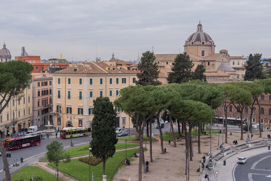 Elevated view from Capitoline Hill showing Rome architecture, Italian pine trees and the dome of Santa Maria in Aracoeli. Calm city scene in cloudy weather.
