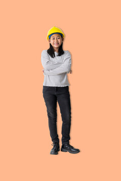 Young girl stands with her arms crossed, smiling, wearing a helmet and standing confidently, representing careers in engineering, construction education. Transparent background.