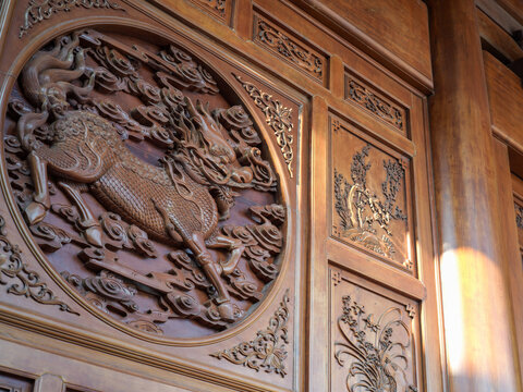 Close-up of exquisite wood carved qilin relief at Funtian Temple in Xiamen Tongan
