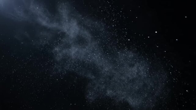 White powder explosion spreading on a dark black background