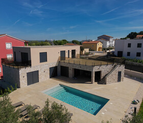Fototapeta premium Aerial view of a modular modern smart house with pool and automated features in progress