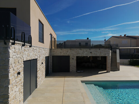 Aerial view of a modular modern smart automated house with pool and unfinished construction details