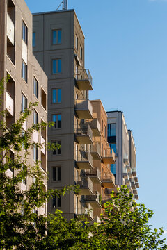 Apartment residential building facade architecture in Stockholm Sweden showing modern perspective with balconies and repeating lines under blue sky