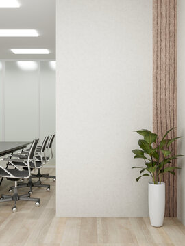 Potted plant on wooden parquet floor aside white wall corner in of a meeting room in office building