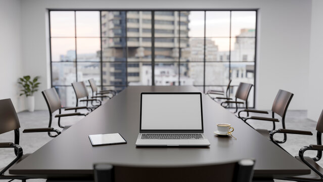 White screen laptop and coffee on meeting table across glass wall of an office in high rise building