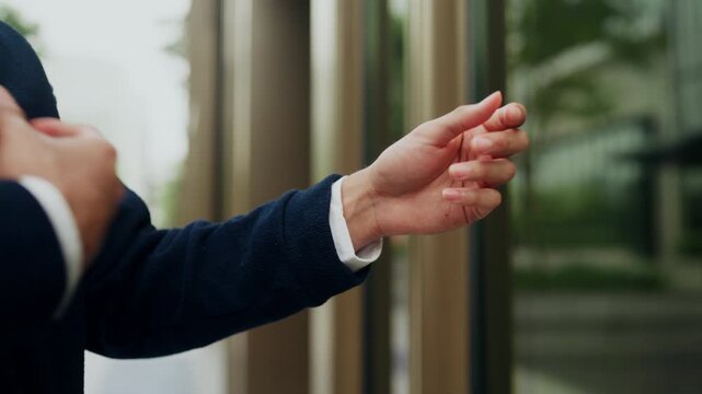 Portrait of young office worker on his way to work, adjusting his smart casual outfit. Quick style check before the day begins, reflecting the blend of work life and everyday professional fashion