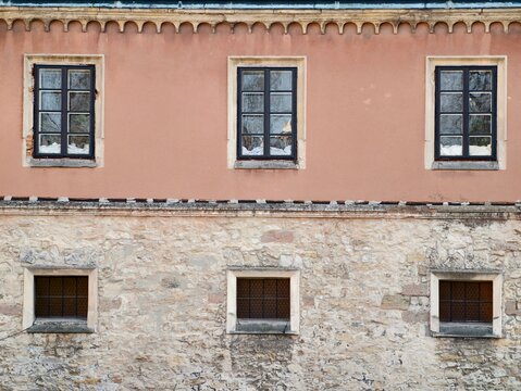 Solid stone foundation with small slit windows and rugged exterior suitable for structural analysis