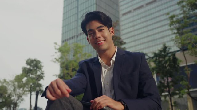 Successful young businessman stands among office towers, smiling with pride, embodying next-gen leadership, quiet ambition, and the drive of modern entrepreneurship in the corporate world