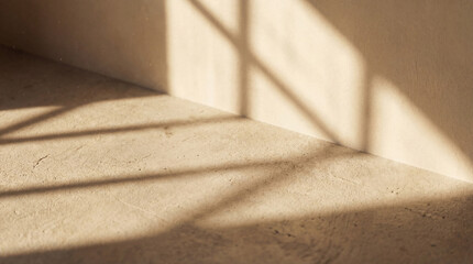 Concrete texture photograph with strong sunlight creating dramatic, angular shadows on a warm-toned surface. © Presiyan