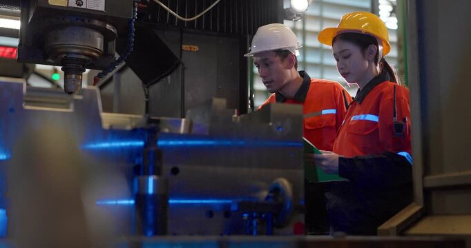 Technicians monitor a CNC machining process inside the machine enclosure during production setup, highlighting inspection, workflow control, and precision manufacturing.
