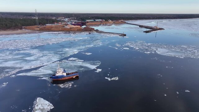 Skulte Port in winter conditions in the Baltic Sea. The main activities of the Skulte port are the export and import of environmentally friendly cargo, fishing, fish processing, and tourism. Primarily