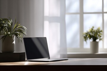 Fototapeta premium Stylish workspace desk with laptop and indoor plants near window